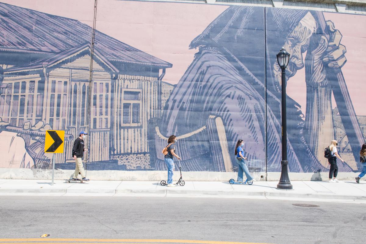 students in front of mural