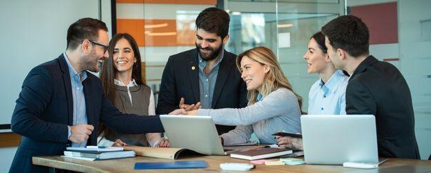 Two people shaking hands in a meeting